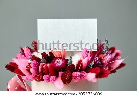 Business card or invitation mockup and dried flower bouquet closeup
