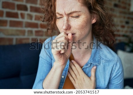 Caucasian red head woman coughing and having lungs infection Royalty-Free Stock Photo #2053741517