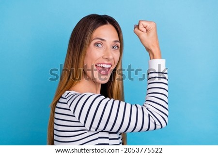 Profile photo of mature blond hooray lady hand fist wear striped shirt isolated on blue color background