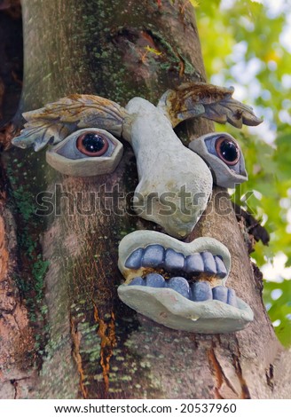 Tree Spirit. Human face decoration on the tree.