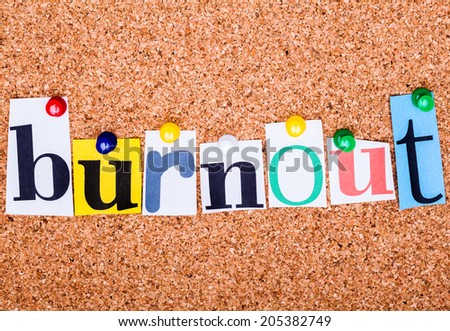 The word Burnout in cut out magazine letters pinned to a cork notice board with push pins