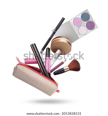 cosmetics flying out of a cosmetic bag on a white background Royalty-Free Stock Photo #2053838531