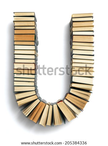 Letter U formed from the page ends of closed vintage hardcover books standing on a white background from a set or series of numbers
