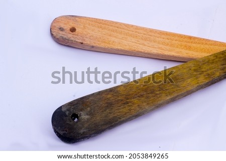 wooden handle of a large wooden spoon
