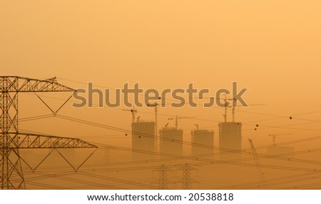 Skyscrapers under construction in the DUbai Desert at dawn with copy space