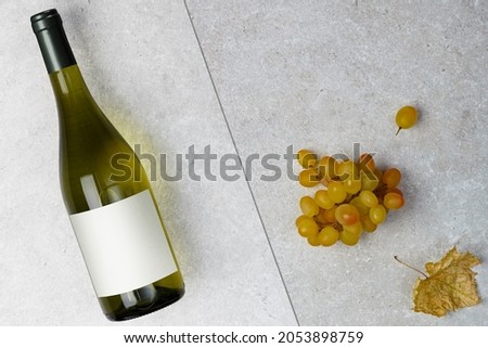 Bottle of white wine with label.  Wine and grape. Wine bottle mockup. Top view.	