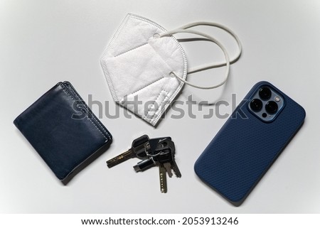 A regular persons everyday carry has changed since covid 19, now it consits of keys, phone, wallet, and a mask.