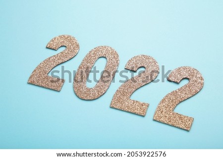 Greeting card with - happy new year with numbers 2022 in gold glitter. Minimal holiday concept. Top view