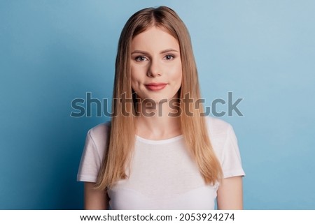 Portrait of charming adorable positive cute woman wear white t-shirt isolated on blue color background