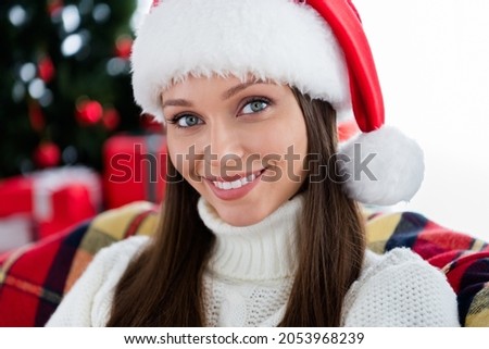 Photo of adorable shiny young woman dressed knitted sweater headwear smiling indoors room home house