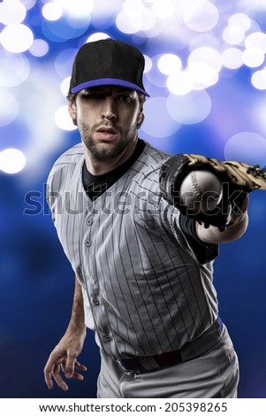 Baseball Player on a Blue Uniform on blue lights background.