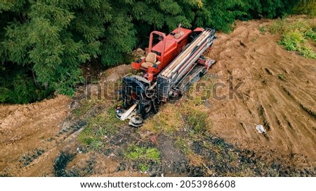 Horizontal directional drilling technology. Aerial view of Drilling machine work process. Trenchless laying of communications, pipes and water pipes. Selective focus Royalty-Free Stock Photo #2053986608