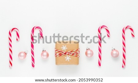Winter holiday banner with gift box, candy canes and Christmas balls. Xmas and New Year festive mockup