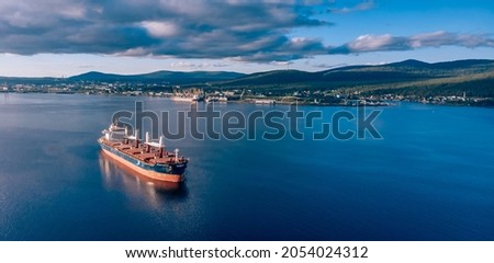 Aerial view of cargo ship in sea Royalty-Free Stock Photo #2054024312