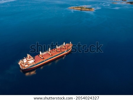 Aerial view of cargo ship in sea Royalty-Free Stock Photo #2054024327