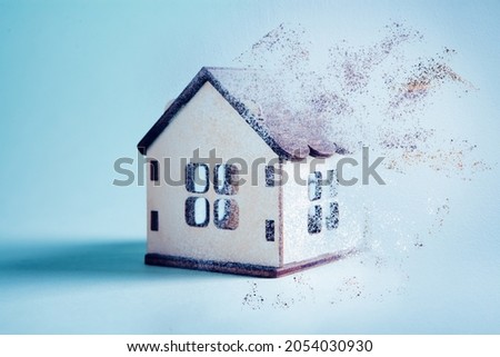 small house disappears on a blue background Royalty-Free Stock Photo #2054030930