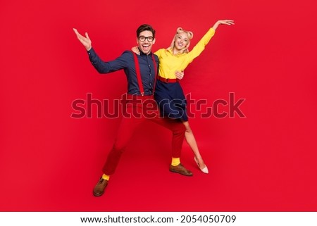 Photo of funny charming young lady guy dressed pinup outfits dancing boogie woogie rising hands arms isolated red color background Royalty-Free Stock Photo #2054050709