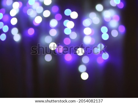 Christmas or New Year festivre blurred background with colorful garland lights.
