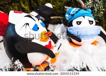 Christmas penguin dolls with a mask, sick with the flu.
