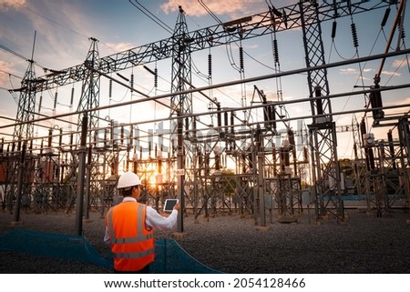 Engineers are checking the operation of the system by laptop, weekly check the system of the power distribution station for errors in the distribution electric system. Royalty-Free Stock Photo #2054128466