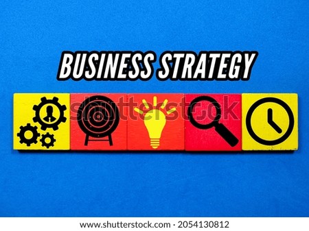 Concept of business strategy and action plan. Wood cube block stacking with icon on blue bsckground.