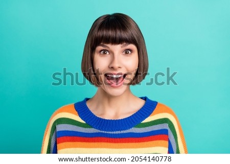 Photo of young excited woman happy positive smile amazed shocked news isolated over turquoise color background