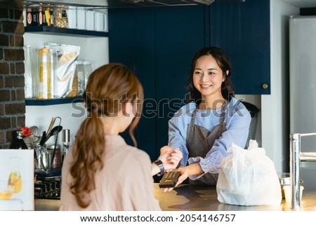 Woman doing smartwatch settlement at cafe (restaurant) Royalty-Free Stock Photo #2054146757
