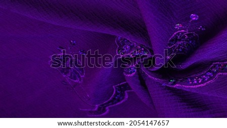 Silk blue. The fabric is embellished with sequins. background, silk satin, luxurious texture, dark fabric, costume cotton material, abstract color image pattern, delicate liquid sapphire velvet