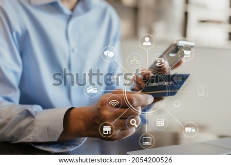Hands holding credit card and using smartphone and laptop. Online shopping.