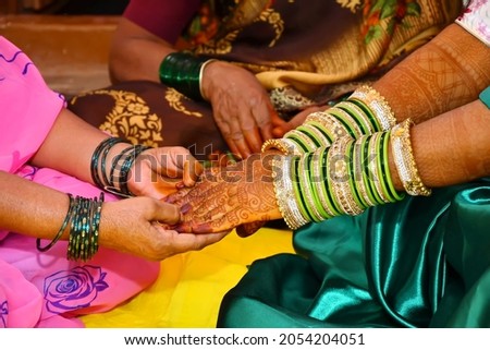 The bride wearing bangles hand closeup bride getting ready for wedding ceremony Royalty-Free Stock Photo #2054204051