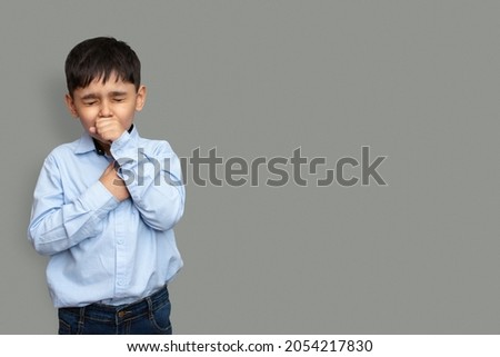 Cute little boy is coughing, on gray background Royalty-Free Stock Photo #2054217830