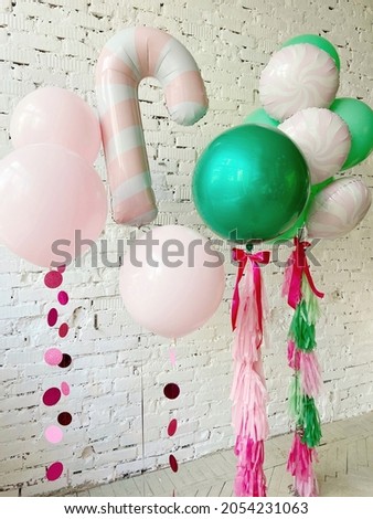 Set of big colorful balloons and foil  candy with paper tails Royalty-Free Stock Photo #2054231063