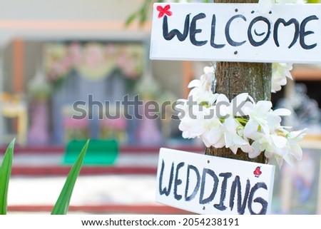 welcome wooden sign with flowers simple wedding sign Comfortable on blurry background and bokeh.