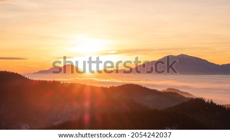 Burning sunrise over the mountains of middle Carinthia from Magdalensberg, Carinthia, Austria Royalty-Free Stock Photo #2054242037