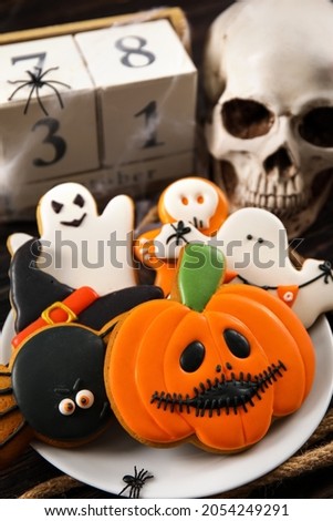 Plate with tasty cookies for Halloween celebration on table