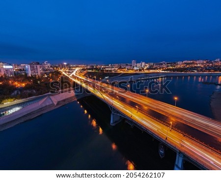 bird's eye view of the bridge and the city behind it in the evening