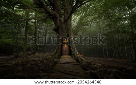 Gigantic tree with house inside Royalty-Free Stock Photo #2054264540