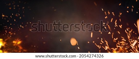 Halloween Witch .  Fire embers particles over black background. Fire sparks background. Abstract dark glitter fire particles lights. 