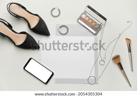 Composition with blank card, female accessories and mobile phone on white background