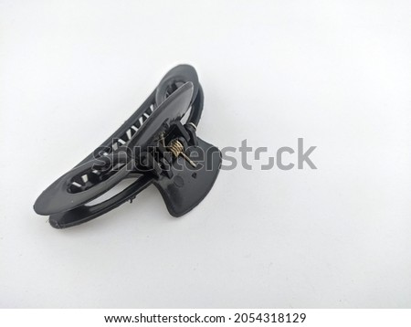 This black plastic hair clip is for clamping thick hair to make it stronger and neater Royalty-Free Stock Photo #2054318129