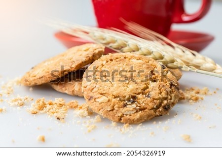 Good morning. Oatmeal cookies and a coffee cup on a wooden table. Selective focus
