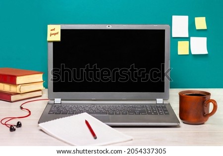 laptop, notepad and coffee mug on the desk. Learning concept