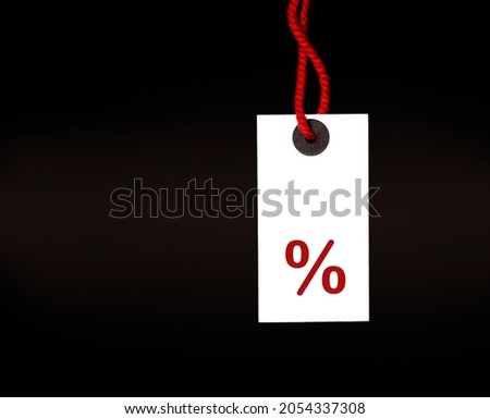 white tag with percent sign on black background