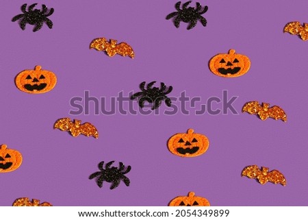 Creative purple pattern made of pumpkin, bat and spiders. Halloween concept Flat flat, top view, copy space