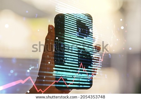 Double exposure of creative Bitcoin symbol hologram and hand with cellphone on background. Mining and blockchain concept