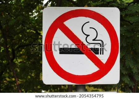 No smoking sign in the public park in the middle of the city  so that people who come to exercise get fresh air