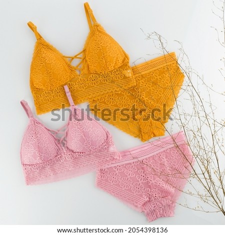 women's underwear, bra, panties, pink, yellow, layout on a white background Royalty-Free Stock Photo #2054398136