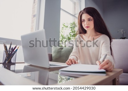 Photo of young business woman sit dest look computer write pen notes to-do list remote work home indoors