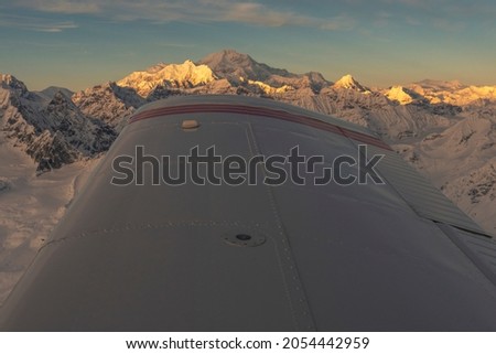 Aerial view of Denali at sunset with airplane wing Royalty-Free Stock Photo #2054442959