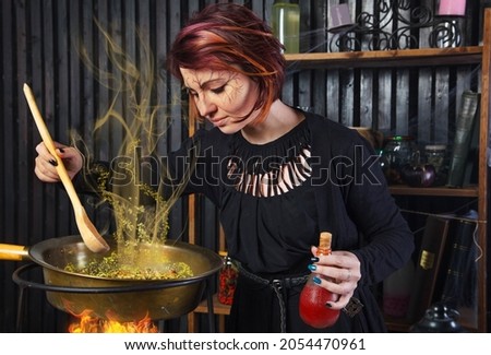 Young beautiful witch preparing a potion for Halloween 